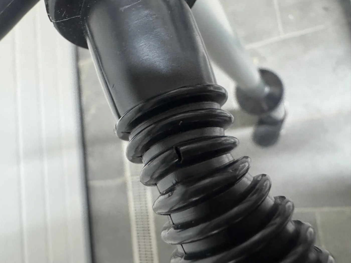 Damaged Fliteboard cable boot at the mast junction — workshop find showing what scheduled servicing catches