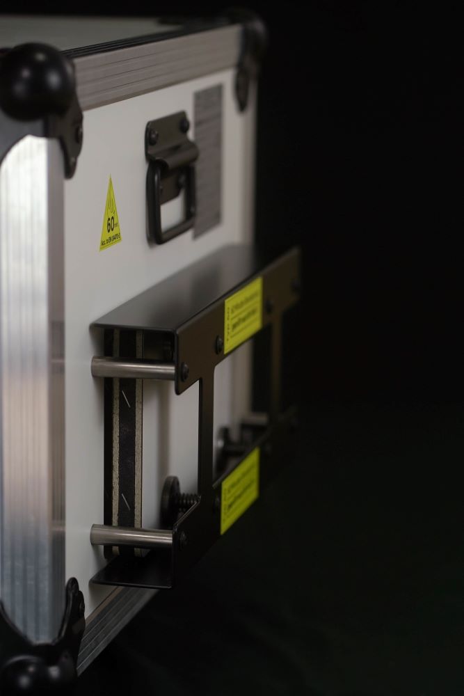 Real photograph showing the inside of an XellBox lithium safety box with the FIPRO vermiculite inner liner visible