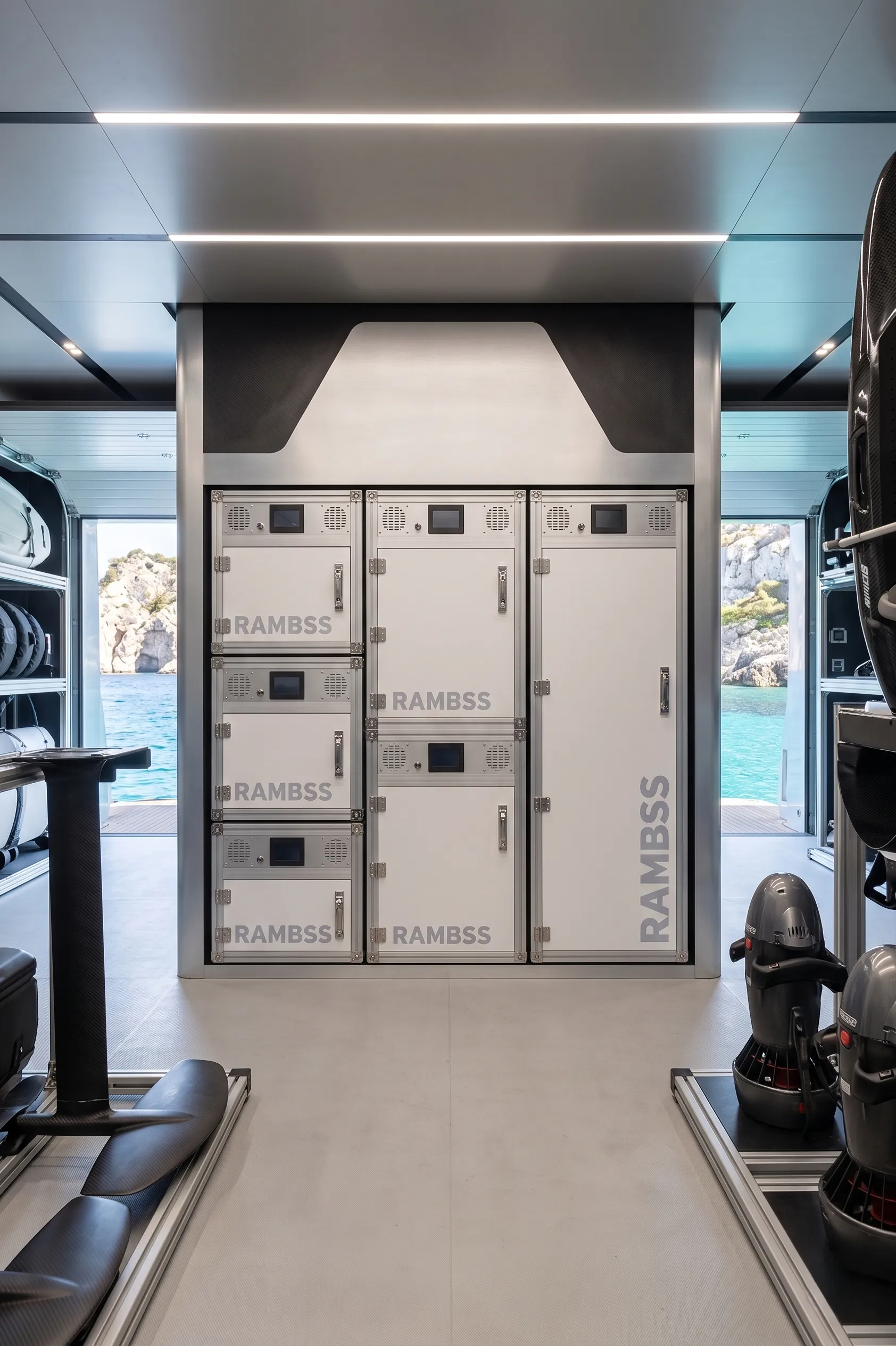 Six interconnected RAMBSS cabinets installed in a superyacht tender garage with eFoils and water toys stored alongside