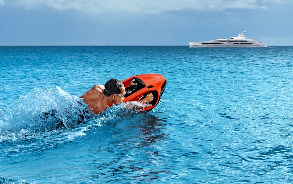 Seabob ridden alongside a Mediterranean superyacht &mdash; the charter use-case the Cayago service rhythm is designed to support