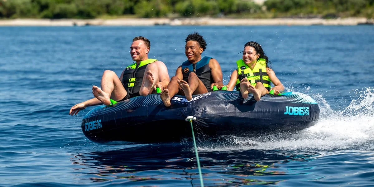 Inflatable towable tube behind tender