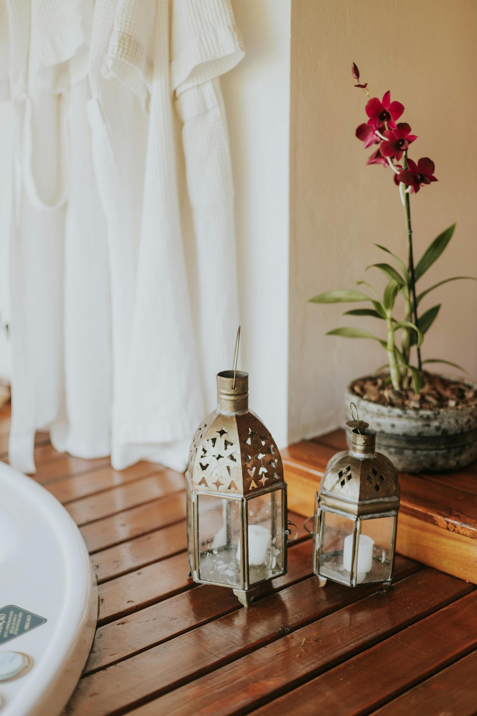 Spa setup detail &mdash; folded white towel, orchid, candle