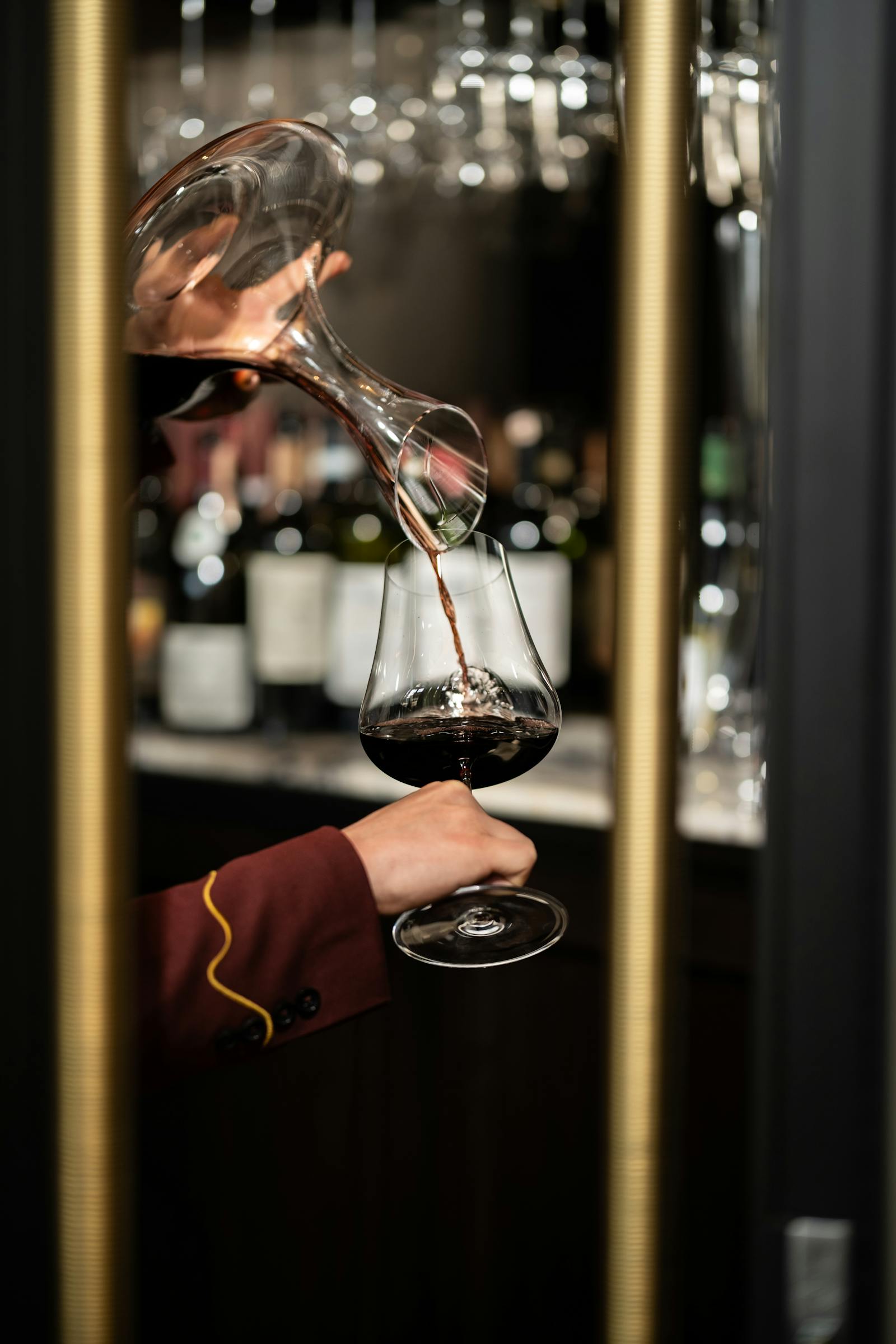 Sommelier pouring red wine close-up