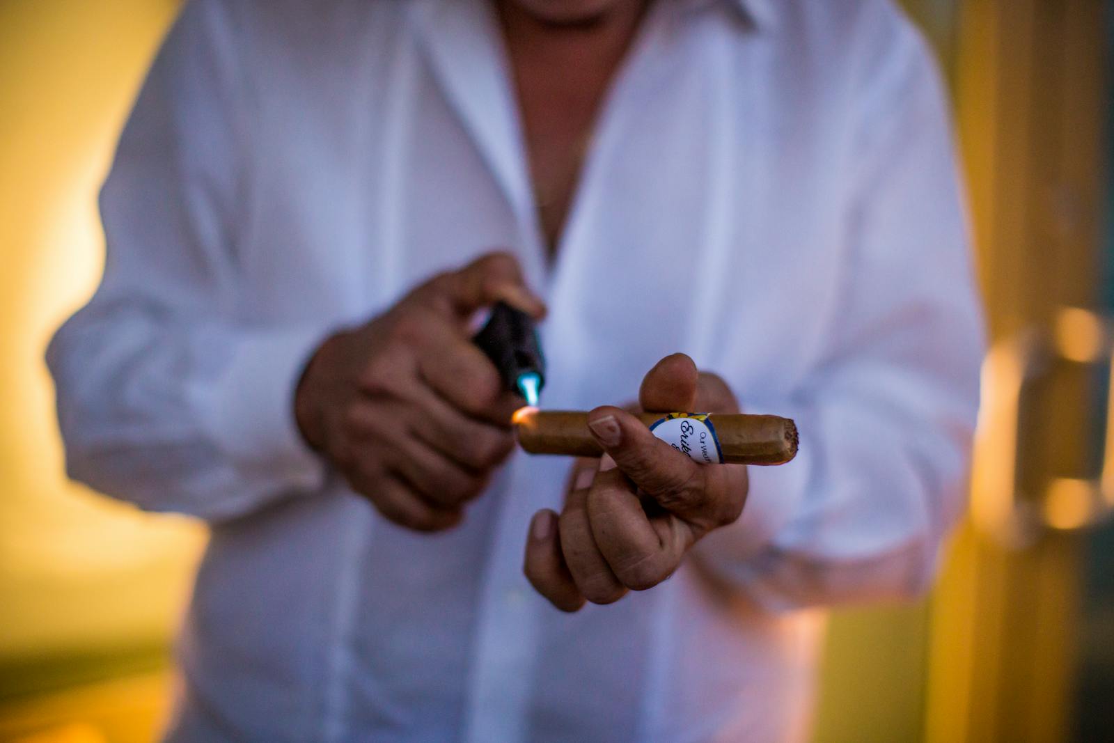 Hands using a cigar cutter close-up