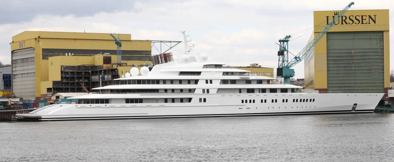A completed superyacht alongside Lürssen's Bremen shipyard — the shipbuilder that delivered the 117-metre Boardwalk